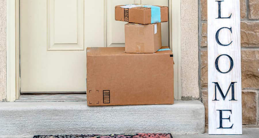 Deliveries on the front porch of a house with a welcome sign in Wilmington